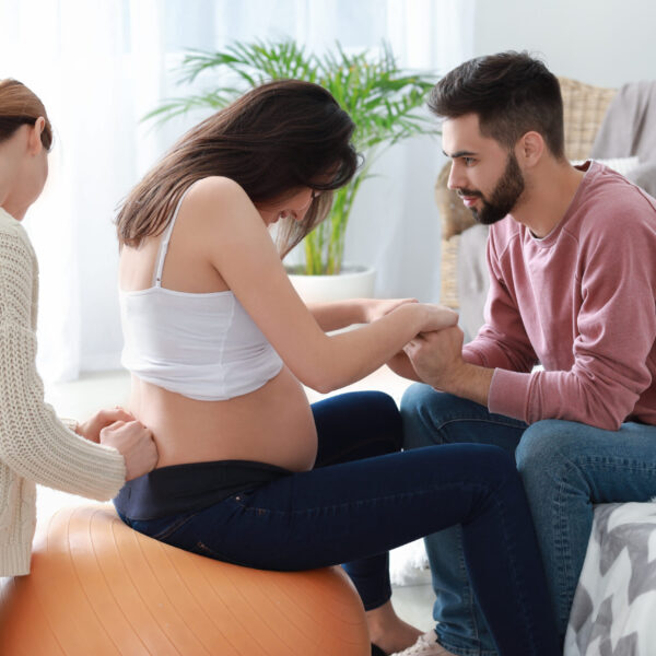 Pregnant couple with doula at home